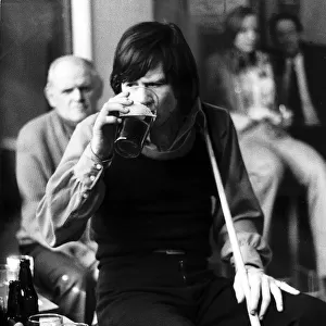 Alex Higgins snooker player drinking a pint of beer April 1973
