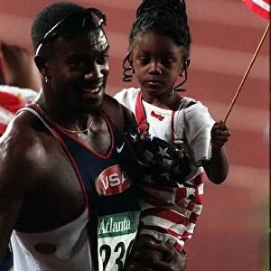 Allen Johnson celebrates with his daughter after winning the gold medal in the 110 metres