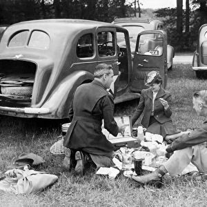American soldiers enjoy a picnic with their English girlfriends during a day out to watch