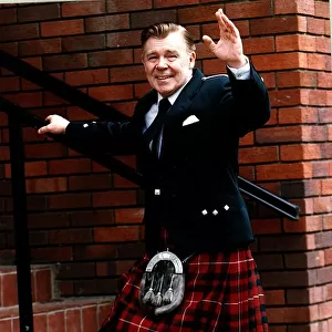 Andy Stewart singer waving going up steps Highland dress kilt Stewart of Bute tartan
