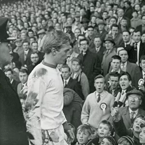 Angry Aston Villa fans jeer Manchester United forward Denis Law as he leaves the pitch
