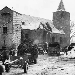An anti-tank gun and its crew of the US 2nd Armored Division entering Dochamps entering