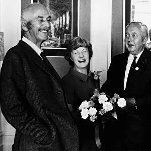Barbara Castle receives cake and flowers on her birthday from Harold Wilson (R) 1971