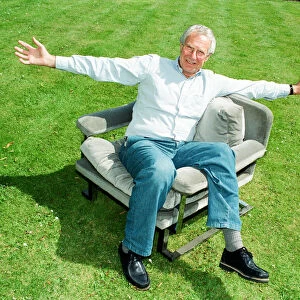 Barry Norman Film Critic seen here in the garden of his Datchworth home with the chair he