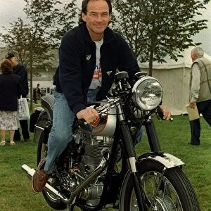 Barry Sheene September 1998. Former world motorcycle champion sitting on an old