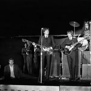 The Beatles performing on stage at the Forest Hills Tennis Stadium in New York during