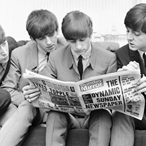 Beatles reading the Sunday Mirror backstage at the Odeon cinema in Leeds