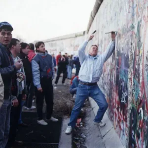 Berlin Wall souvenir hunter chip at the wall for memorabilia before it is demolished