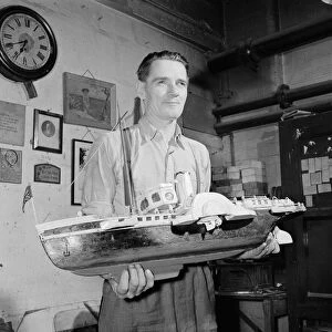 A blind model maker completes his latest model boat Circa 1957