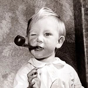 Boy smoking a pipe, circa 1950
