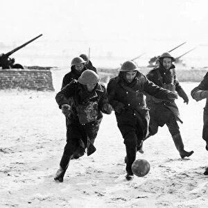 British anti aircraft battery playing football in a snow-covered French field. WW2 1940