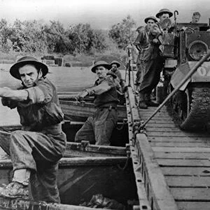 British army engineers move across the Volturno River, near the Castello Volturno in a