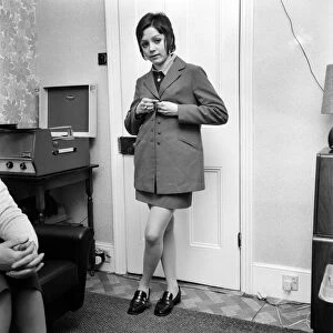 British family feature: Young teenage girl dressed in school uniform in her living room