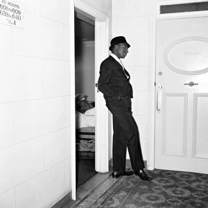 Cassius Clays bodyguard Ronald King keeps watch outside the Piccadilly Hotel room
