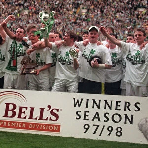Celtic football players celebrate winning the championship 1998 with trophy cup winners