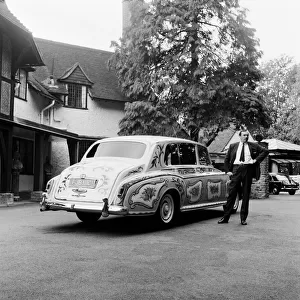 The chauffeur of The Beatles singer John Lennon standing beside Lennon