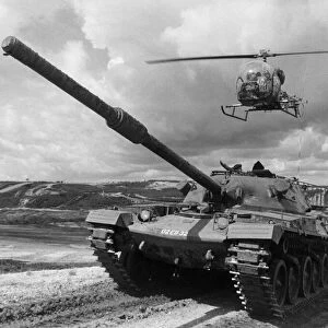A Chieftan tank of the Royal Amoured Corp seen here on exercise with a army helicopter