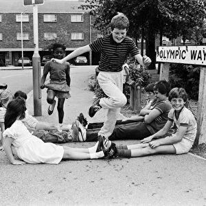 Children of Olympic Way in London, playing a game on the streets outside their homes