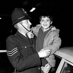 Children with policemen: A six year old boy who calls himself George Mason is