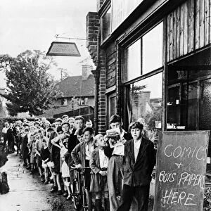 Children queue up outside a shop for comics in Eltham, London during World War Two
