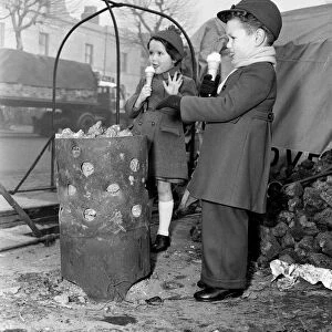 Children warming themselves round the watchmans fire. 5th January 1956