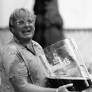 Christopher Biggins with giant glass of Grants Whisky 1989