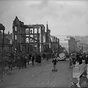 Civilians walk amongst the ruins of Dolphin Street following a further raid on Bristol by
