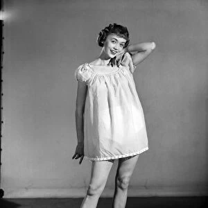 Clothing: Fashion: Nightwear: Woman wearing night dress. 1955 B409-002