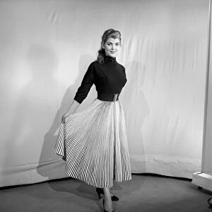 Clothing: Fashion: Skirts: Woman wearing pleated skirt. 1953 B127-002