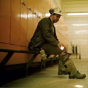 A coal miner at Ellington Colliery in Northumberland sitting in the locker room after his