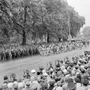 The Coronation of Queen Elizabeth II. Crowds of people watch as the procession
