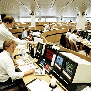 A currency dealer studies a computer screen at the Natwest Bank trading floor in London