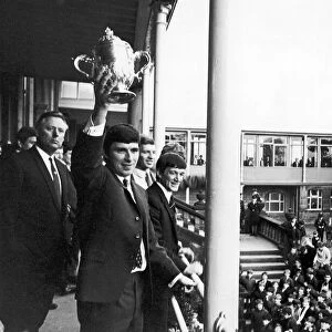 Derby County footballer Kevin Hector proudly holds aloft the Division Two Championship