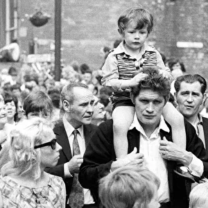 Durham Miners Gala - A child is carried on their fathers shoulders during the march