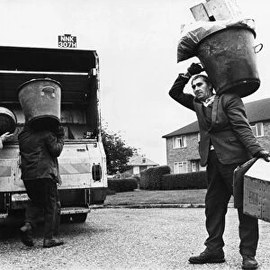 Dustbin men doing their rounds in the city of Cambridge. Circa 1970s