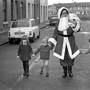 An elderly woman dressed as Santa Claus on her way to an engagement accompanied by