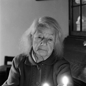 Elderly woman, drinking a cup of tea, by candlelight, Perry Barr, Birmingham