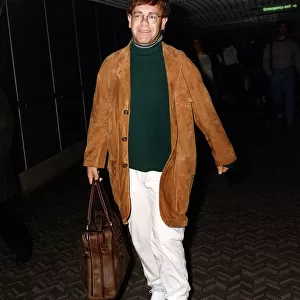 Elton John singer arriving at an airport
