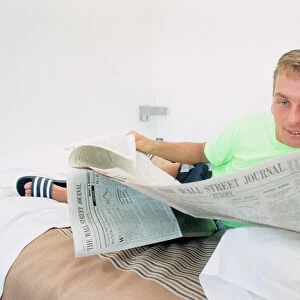 England footballer David Platt seen here reading the Wall Street Journal at the team base