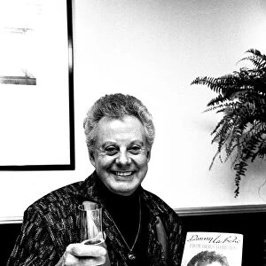 Entertainer Danny La Rue at a Newcastle restaurant signing copies of his autobiography