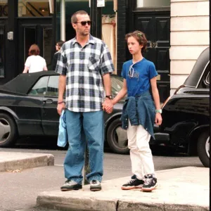 Eric Clapton musician and his daughter hold hands as they shop in the Kings Road London