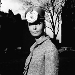 Fashion model Mignon Madden models a hat with flower decoration designed by Graham Smith