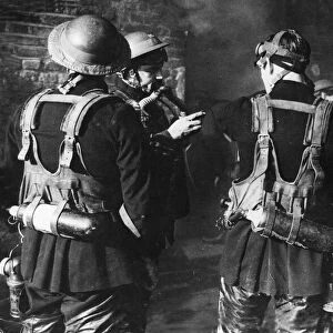 Firemen The London Fire Brigade. Checking their oxygen masks during the Blitz