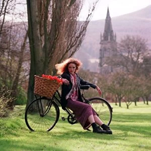 Flower power fashion feature 1998 girl in gardens country side bike basket trees