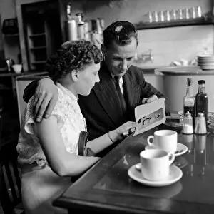 Food: Eating out: Couple in cafe in the West End of London. August 1953 D5148-002