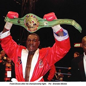 Frank Bruno hold aloft his WBC World Boxing Council Championship belt after defeating