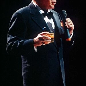 Frank Sinatra sings in concert with drink in hand