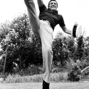 Frankie Vaughan singer and entertainer May 1974 kicking foot high up in air