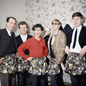 Freddie and the Dreamers pop group pose with swimming trunks presented to them by their