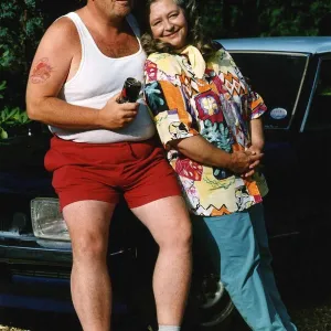 Geoffrey Hughes actor sitting on car bonnet